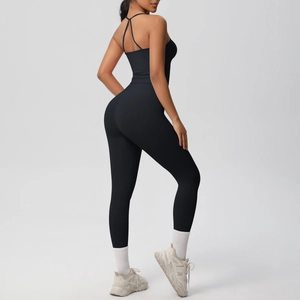 Close-up of black one-piece yoga bodysuit featuring cross-back straps and lifting leggings