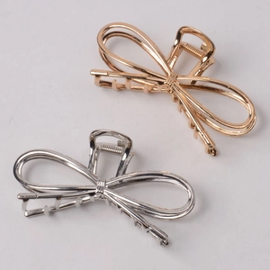 Elegant gold and silver alloy bow hair claws for women in a minimalist geometric design