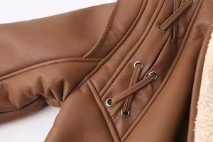 Détail d'une veste en similicuir marron avec doublure en peau de mouton et lacets