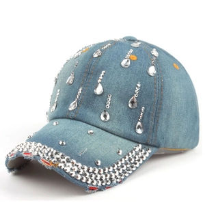 Close-up of blue denim baseball cap with sparkling rhinestones and drop crystal details