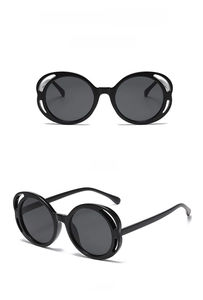Front and side views of fashionable oval hollow black sunglasses on white background