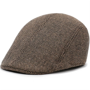 Detailed view of the brown herringbone wool texture on a classic winter flat cap