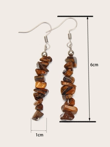 Detail shot of brown natural stone earrings showing 6cm length and 1cm width dimensions