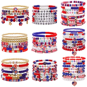 Detail view of 4th of July beaded bracelets with USA and Liberty charms in red white and blue
