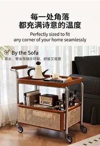 Detail of double-tier trolley with stainless steel frame and vintage rattan storage basket