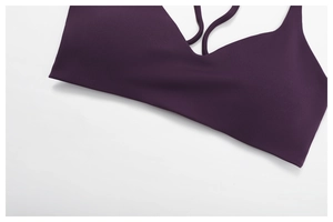 Detail of plum seamless yoga bra featuring V-neckline and slender shoulder straps