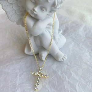 Elegant gold S925 sterling silver cross necklace with zircons on white angel statue