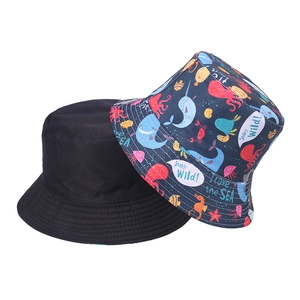 Reversible bucket hat with cartoon ocean shark print and solid black cotton twill design
