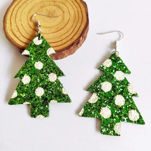 Detail of Christmas tree shaped leather earrings with green glitter and white polka dots