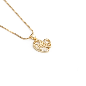Detailed view of a gold heart-shaped pendant with Mom lettering and zircon accents