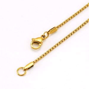 Close-up of golden stainless steel chain with lobster clasp and round end ring
