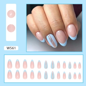 Detail of pink press-on nails with blue French tips and sparkling glitter stripes