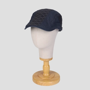 Detail of vintage denim newsboy cap with diamond quilted patchwork on the crown
