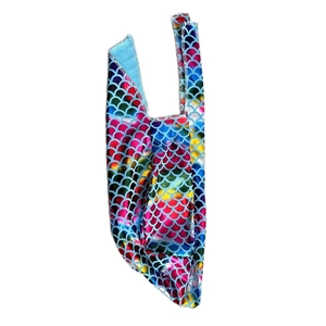 Close-up of holographic fish scale pattern fabric with colorful metallic finish detail