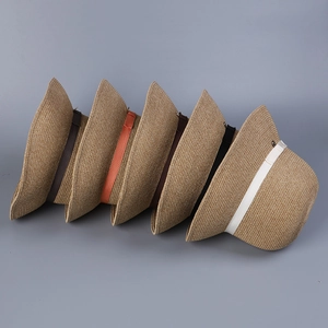 Close-up of stacked breathable plant fiber sun hats showing various ribbon color options