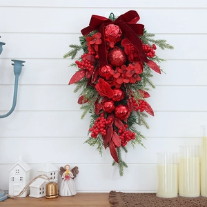 Upside-down Christmas tree wall hanging with red bows, berries, and pine needles