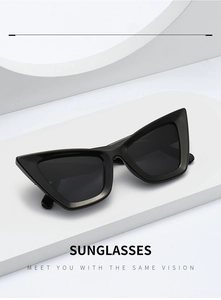 Detailed view of black cat-eye sunglasses placed on a minimalist white geometric display