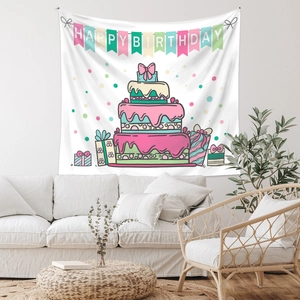 Detail of Happy Birthday tapestry featuring cake design over a modern white sofa