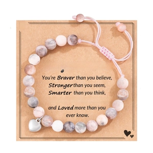 Pink and grey stone bead bracelet with heart charm on inspirational gift card