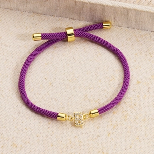 Detail of adjustable purple woven bracelet with gold-plated micro-pave zircon letter B