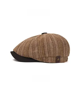 Detail view of vintage newsboy cap with brown stripes and side leather brand metal buckle
