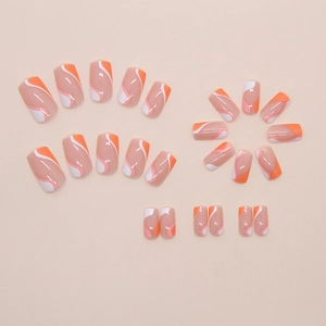 Short square press-on nails featuring orange and white wave patterns on a nude pink base