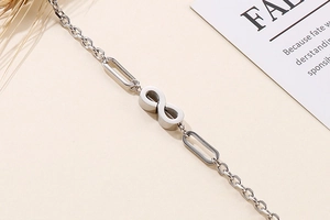 Detail of silver infinity symbol bracelet with O-chain and textured metal links