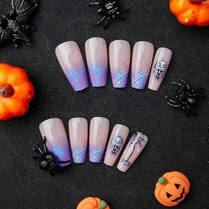 Blue and purple Halloween coffin nails with spider web and skull motifs on dark background