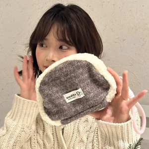 Detail showing the plush fleece trim and woven logo label on the wool shell bag