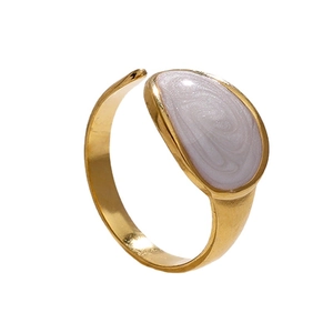 Adjustable golden stainless steel ring featuring a white pearlescent oval inlay detail