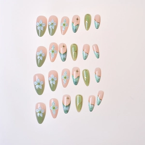 Detail view of almond press-on nails featuring marble ink and 3D white floral designs