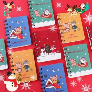Detail of colorful Christmas spiral notebooks with cartoon patterns and Merry Christmas text