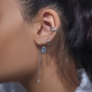 Close-up of S925 silver fringe chain earrings with blue rectangle gemstones and ear cuffs