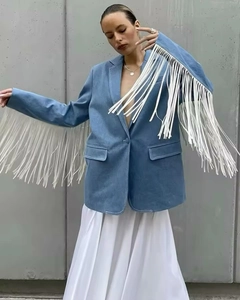 Detail of blue wool blazer showing decorative white fringe on sleeves and flap pocket