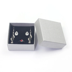 Elegant jewelry gift set with red gemstone ring and silver earrings in a premium box