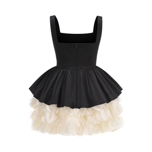 Back view of elegant black and white party dress with cream pleated petal hem and zipper
