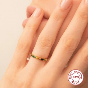 Detail of 925 sterling silver ring with colorful stones on model finger