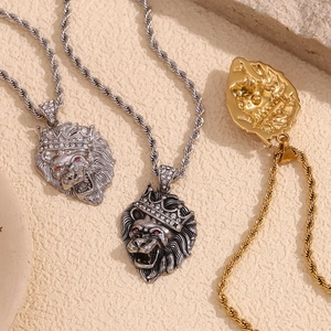 Detailed close-up of crown lion head pendants in gold, silver, and vintage silver finishes