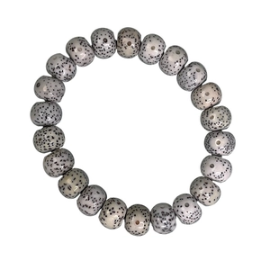 Polished star moon bodhi seed bracelet with creamy white beads and natural dark speckles