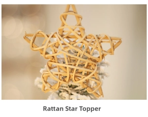 Macro shot of natural rattan star tree topper with rustic white snow finish and warm lights