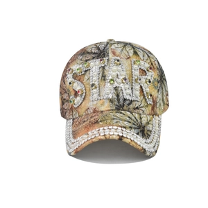 Detailed close-up of a vintage baseball cap with floral print and pearl-studded STAR logo