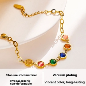 Close-up of titanium steel bracelet featuring colorful cat-eye gemstones and vacuum plating