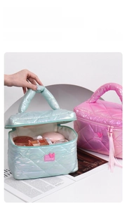 Iridescent quilted cosmetic bag with metal heart logo showing storage for makeup products