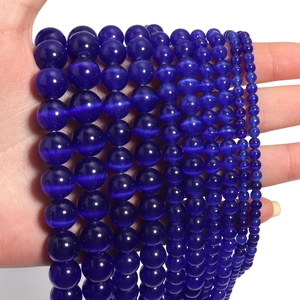Macro shot of blue round cat eye opal beads in various sizes for DIY jewelry making