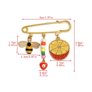 Detailed size specifications of the gold safety pin with bee and orange slice charms