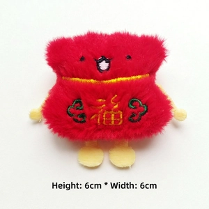 Detail of red plush fortune bag charm with gold blessing embroidery, size 6cm x 6cm