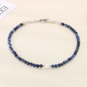Detailed shot of blue natural stone beads and pearl necklace with stainless steel OT buckle