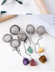 Detail of 304 stainless steel tea infuser featuring a natural amethyst stone pendant