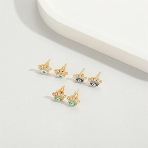 Three pairs of Evil Eye stud earrings with blue and green zircons in gold settings