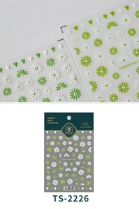Macro detail of 5D embossed daisy nail decals with green and white floral textures